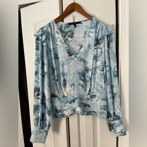 Very nice WHBM blue print blouse with side zip. In like new condition.